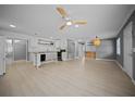 Spacious living room featuring wood-look floors, modern lighting, and an open layout at 219 Marion Oaks Ln, Ocala, FL 34473