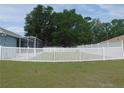 Backyard featuring a well maintained lawn and a newly installed white vinyl privacy fence at 2909 Ne 25Th St, Ocala, FL 34470