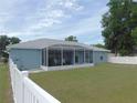 A screened-in porch adds extra space to this property, surrounded by a well-maintained backyard with a privacy fence at 2909 Ne 25Th St, Ocala, FL 34470
