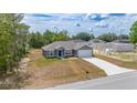 A charming single-Gathering home boasts a manicured lawn and concrete driveway with a fresh construction next door at 400 Mariion Oaks Crse, Ocala, FL 34473