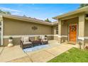 Charming front porch featuring a cute seating area with outdoor furniture and a decorated front door at 5263 Nw 62Nd Nw Ave, Ocala, FL 34482