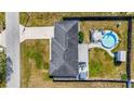 Aerial view of a home featuring a backyard pool, patio area, privacy fence, and extended driveway at 7 Larch Dr, Ocala, FL 34480