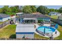 Aerial view of a home with an above ground pool, shed, patio, and well manicured backyard at 7 Larch Dr, Ocala, FL 34480
