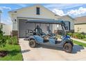 Inviting home featuring a golf cart and a well-manicured lawn at 7206 Sw 60Th Ln, Ocala, FL 34474