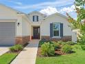 Charming home featuring stone accents, a black front door, and a landscaped lawn at 7206 Sw 60Th Ln, Ocala, FL 34474