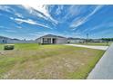 Well-maintained single-story home with a green lawn and a concrete driveway at 8943 Se 41St Court Rd, Ocala, FL 34480