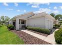 Charming one-story home with manicured lawn, neutral siding, and attached two-car garage at 9408 Se 132Nd Loop, Summerfield, FL 34491