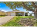 Inviting single-story home with a spacious front yard and a well-manicured lawn at 9750 Sw 97Th Pl, Ocala, FL 34481