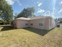 Backyard with lush green grass, offering a private retreat with ample space for recreation and outdoor activities at 1001 Ne 22Nd Ave, Ocala, FL 34470