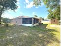 Spacious backyard features a screened lanai, providing an ideal space for outdoor relaxation and entertaining guests at 1001 Ne 22Nd Ave, Ocala, FL 34470