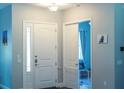 Inviting entryway featuring clean white trim and a gray accent wall at 10208 Se 170 Pl, Summerfield, FL 34491