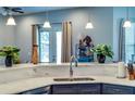 Bright kitchen features sleek countertops, stainless steel sink, and modern pendant lighting at 10208 Se 170 Pl, Summerfield, FL 34491