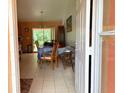 Cozy dining area with tile flooring, wooden furniture, and sliding glass doors leading to the backyard at 14 Dogwood Drive Radl, Ocala, FL 34472