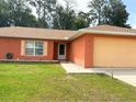 Charming single-story home featuring a well-maintained lawn and a two-car garage at 14 Dogwood Drive Radl, Ocala, FL 34472