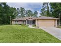 Charming one-story home with a well-maintained lawn and attached garage at 14330 Sw 79Th Ter, Ocala, FL 34473