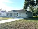 Charming single-story home with a manicured lawn and attached one car garage at 14415 Sw 21St Pl, Ocala, FL 34481
