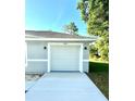 Attached one car garage with visible house numbers and new concrete at 14415 Sw 21St Pl, Ocala, FL 34481