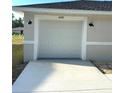 Attached garage features updated exterior lighting and a well maintained concrete driveway at 14425 Sw 21St Pl, Ocala, FL 34481