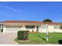 Charming single-story home featuring a well-maintained front yard and attached two-car garage at 17574 Se 95Th Ct, Summerfield, FL 34491