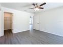 Bright and airy bedroom with a ceiling fan, a walk-in closet, and light gray wood-look floors at 22777 Sw Beach Blvd, Dunnellon, FL 34431