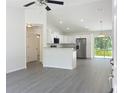Open-concept interior showcasing sleek gray flooring, modern stainless appliances, and bright natural light at 22777 Sw Beach Blvd, Dunnellon, FL 34431