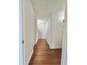 Hallway with beautiful wood flooring, white walls, and plenty of storage space at 3005 Ne 19Th Ave, Ocala, FL 34479