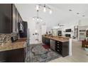 Well-equipped kitchen with stainless steel appliances, granite countertops, and dark wood cabinetry at 3880 Sw 6Th Ave, Ocala, FL 34471