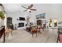 Bright and airy living room with whitewashed brick fireplace, vaulted ceilings, and modern fan at 3880 Sw 6Th Ave, Ocala, FL 34471