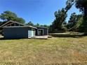 Exterior view of a blue home with a wooden deck, perfect for outdoor entertaining and relaxation at 4000 Sw 6Th Ave, Ocala, FL 34471