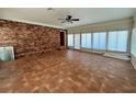 Spacious living room with brick accent wall, tile floors, and lots of natural light at 4000 Sw 6Th Ave, Ocala, FL 34471