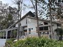 Charming two-story home with a screened-in porch and outdoor seating area at 4305 Sw 20Th Ave, Ocala, FL 34471