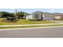 Attractive home featuring manicured landscaping, an attached garage, and a well-maintained lawn adding to its appeal at 4892 Nw 39Th Loop, Ocala, FL 34482