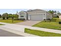 Inviting home with an attached garage, landscaped front yard, and a brick-paved driveway leading to the entrance at 4892 Nw 39Th Loop, Ocala, FL 34482