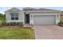A lovely home featuring a gray exterior and a brick driveway at 4892 Nw 39Th Loop, Ocala, FL 34482