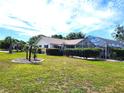 Lush backyard featuring a screened-in lanai and a well-maintained lawn at 6312 Sw 60Th Ct, Ocala, FL 34474
