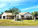 Attractive home exterior featuring a lush, green lawn, and inviting landscaping at 6312 Sw 60Th Ct, Ocala, FL 34474