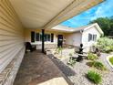Inviting front porch with brick accents, a cozy seating area, and a charming fountain at 6312 Sw 60Th Ct, Ocala, FL 34474