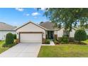 Inviting single-story home boasts a two-car garage, well-kept lawn, and charming landscaping at 7263 Sw 99Th Cir, Ocala, FL 34481