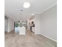Open-concept kitchen and living area boasts modern appliances, granite countertops, and tile flooring at 7987 Sw 89Th Cir, Ocala, FL 34481