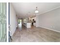 Open-concept living room featuring tile flooring, an eat-in kitchen with an island, and a seamless flow for modern living at 7987 Sw 89Th Cir, Ocala, FL 34481