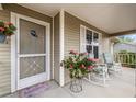 Cozy front porch adorned with rocking chairs and floral accents, perfect for relaxing outdoors at 8137 Sw 117Th Loop, Ocala, FL 34481