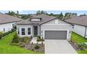Single-story home showcasing well-manicured landscaping, a two-car garage, and a welcoming front entrance at 8809 Sw 61St Loop, Ocala, FL 34481