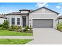 Charming single-story home showcasing well-manicured landscaping, a two-car garage, and a welcoming front entrance at 8809 Sw 61St Loop, Ocala, FL 34481