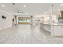 Open-concept living space featuring tile floors, neutral paint, recessed lighting, and seamless transition to an outdoor patio at 9777 Sw 63Rd Loop, Ocala, FL 34481