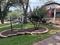 Scenic view of a well-maintained front yard showcasing lush greenery and charming landscaping at 9801 Sw 88Th Ter # B, Ocala, FL 34481