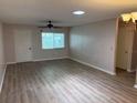 Bright living room featuring modern laminate flooring, neutral paint and natural light at 9801 Sw 88Th Ter # B, Ocala, FL 34481