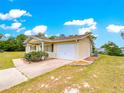 Single-story home featuring a single-car garage and verdant front lawn at 10520 Sw 85Th Ter, Ocala, FL 34481