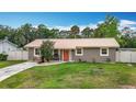Well-kept house has a metal roof, green lawn, and concrete pathway at 1520 Ne 17Th Ave, Ocala, FL 34470