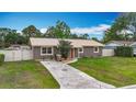 Charming home with a metal roof, neat landscaping, and a concrete driveway at 1520 Ne 17Th Ave, Ocala, FL 34470