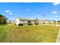 Inviting single-story home with a lush green lawn and a view of neighboring houses on a bright, sunny day at 17890 Se 96Th Ct, Summerfield, FL 34491
